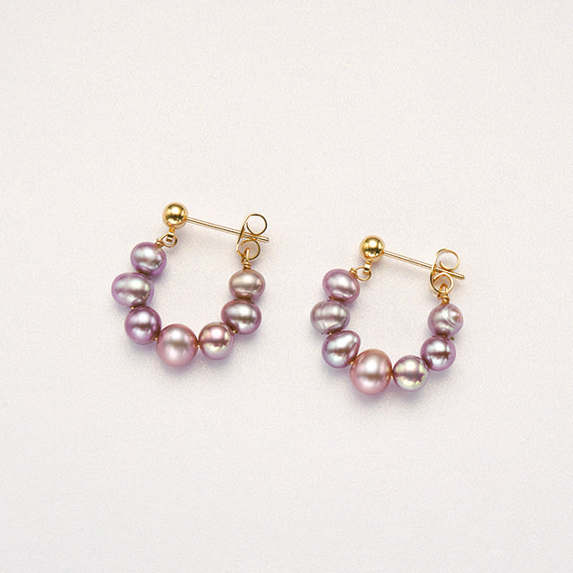 A pair of purple pearl new look earrings.