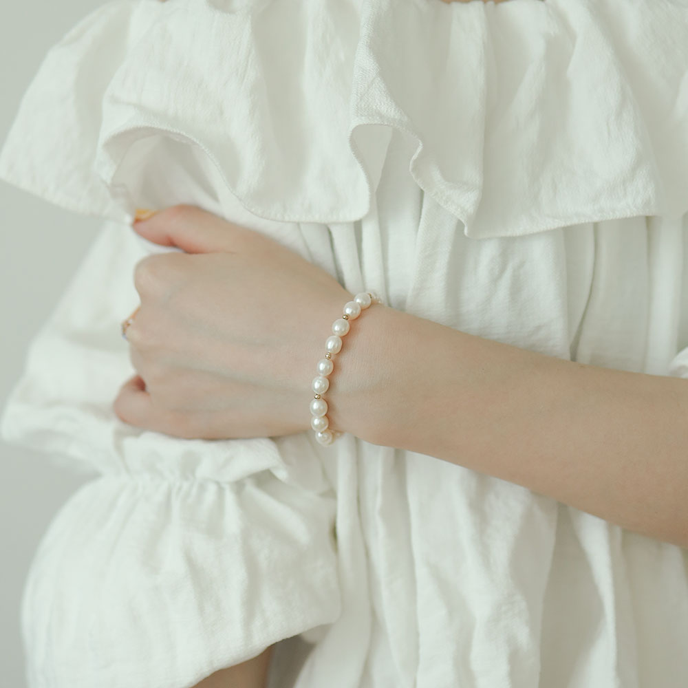 Women wear a real pearl bracelet.