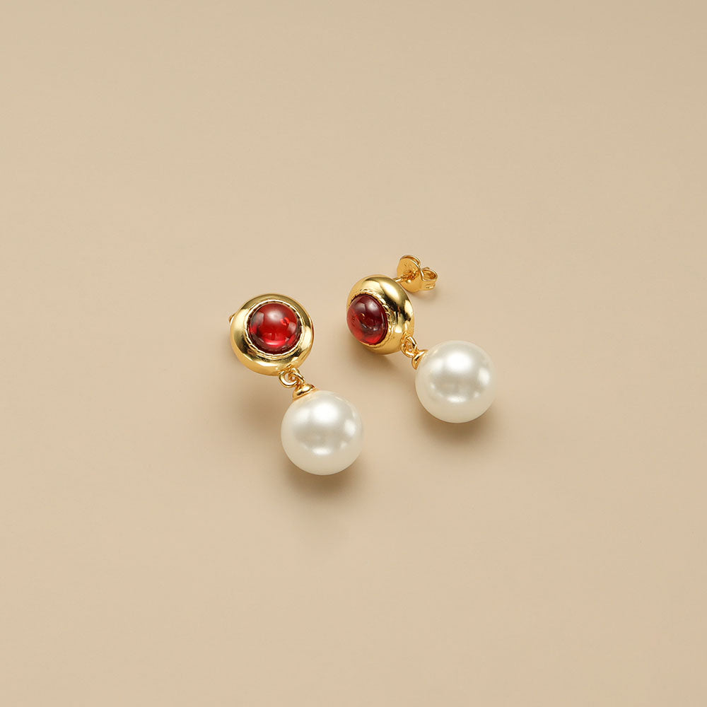 A pair of red dangle earrings.