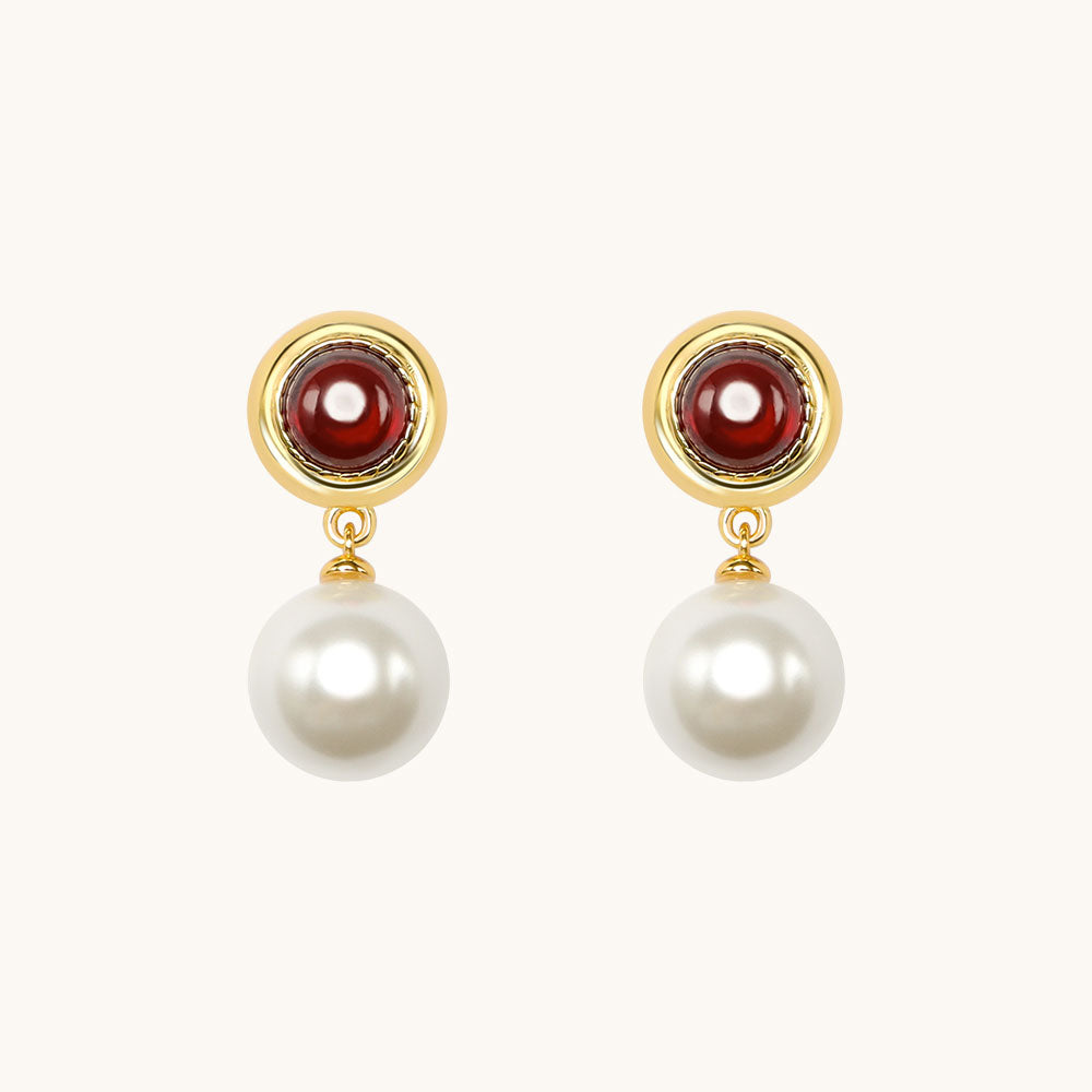 A pair of red pearl stone earrings.