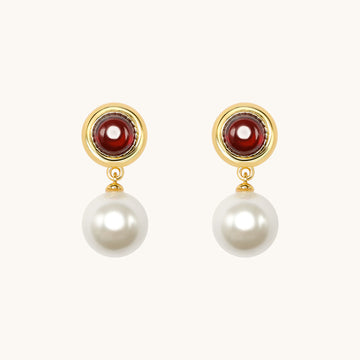 A pair of red pearl stone earrings.