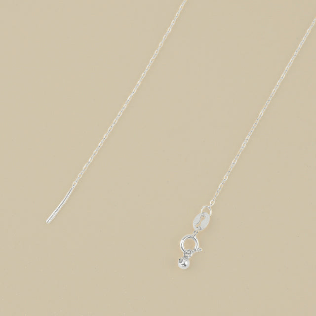 A silver adjustable necklace clasp.