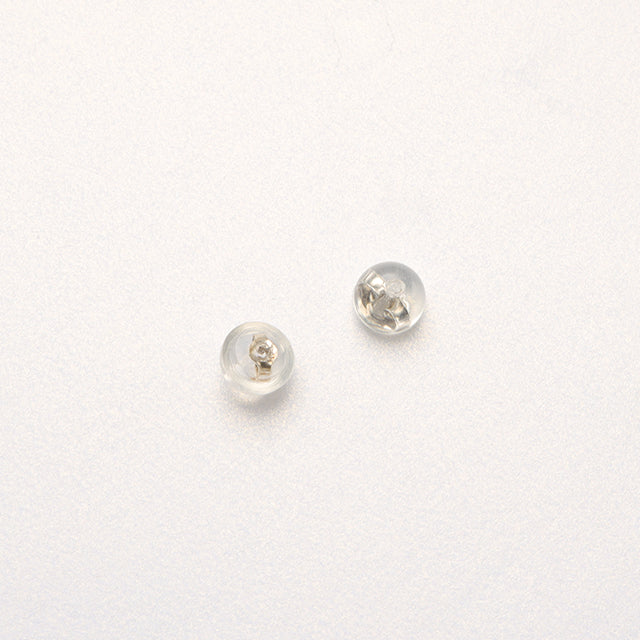 A pair of silver and rubber earrings backs.