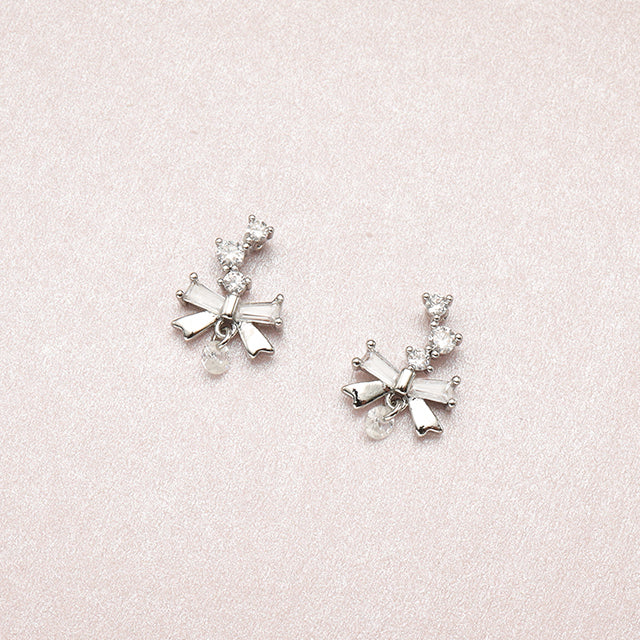 A pair of silver beauty bow tiny diamond earrings.