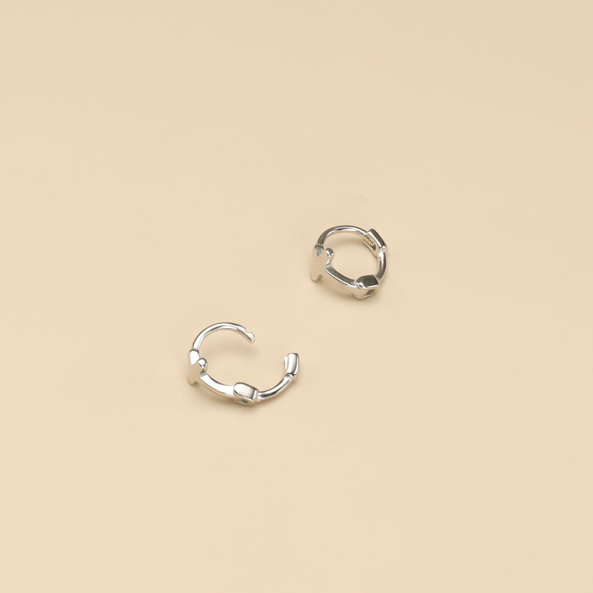 A pair of silver cross earrings.
