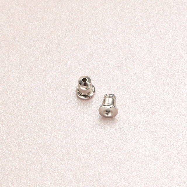 A pair of silver earrings backs.