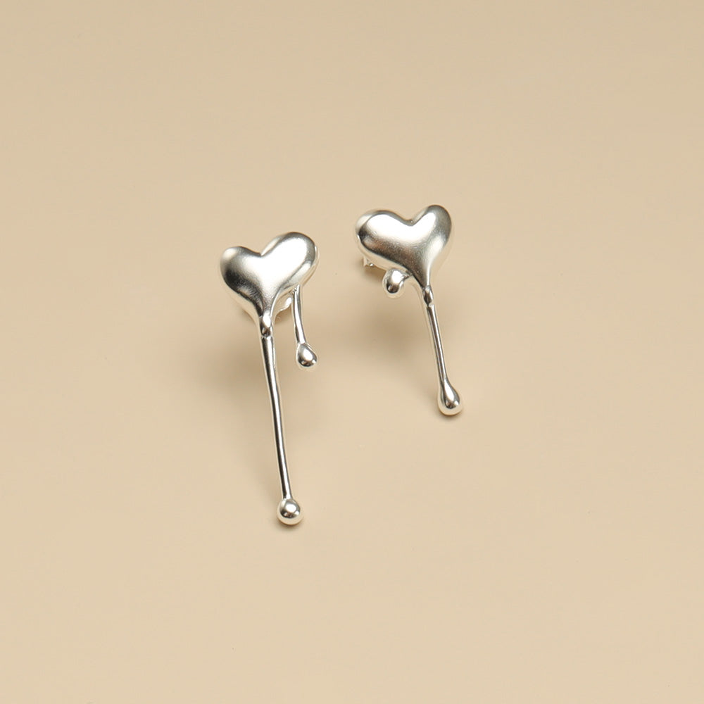 A pair of silver heart earrings.