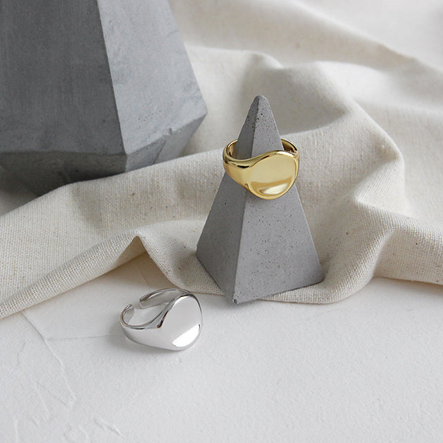 Simple gold and silver signet ring on stone.