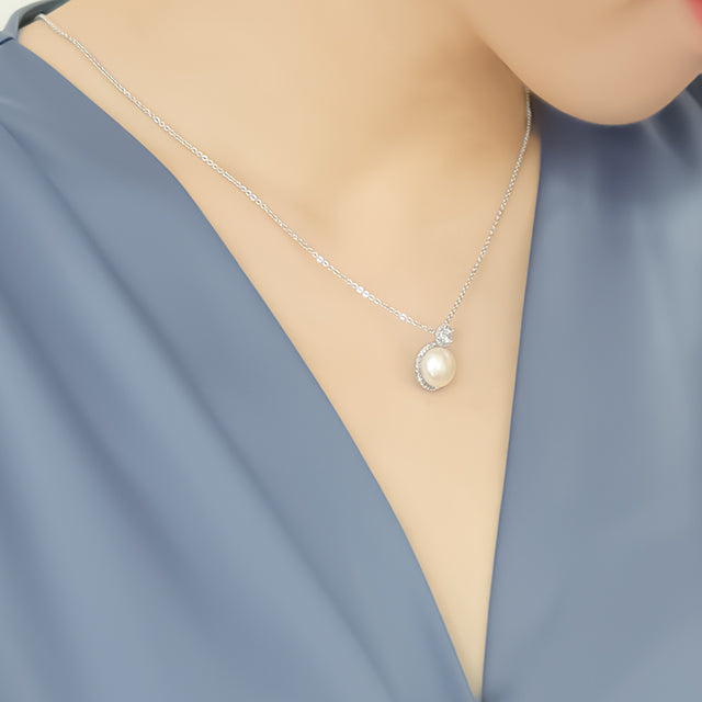 A single pearl necklace on women's neck.