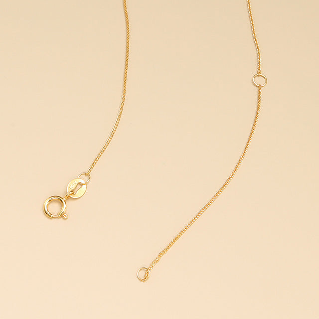 Small gold chain with adjustable spring ring clasp.