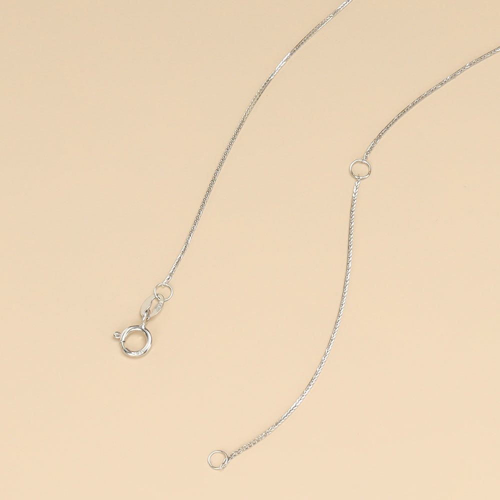 A small white gold chain with spring ring clasp.