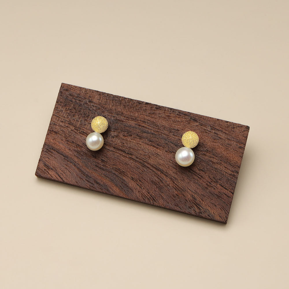 Small gold pearl earrings.