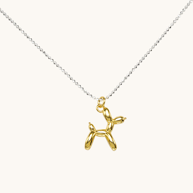 A small necklace with gold dog pendant.