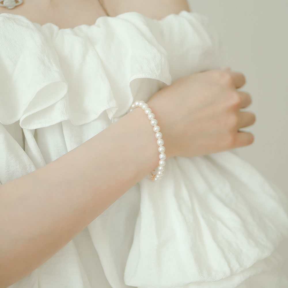 Women wear small pearl bracelet.