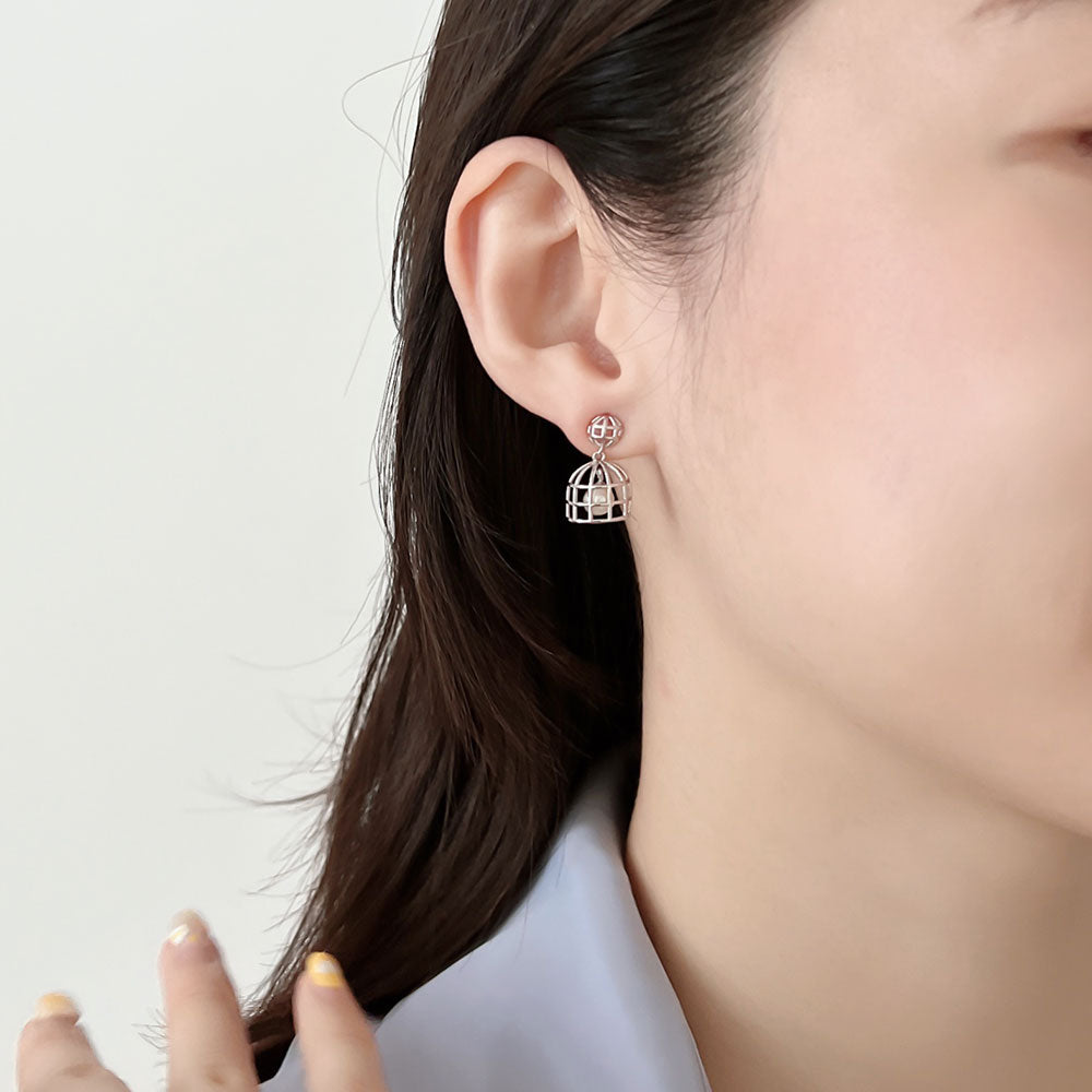 Small silver pearl earrings.