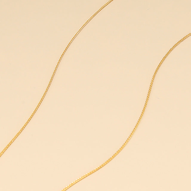 A close shot of thin gold chain.