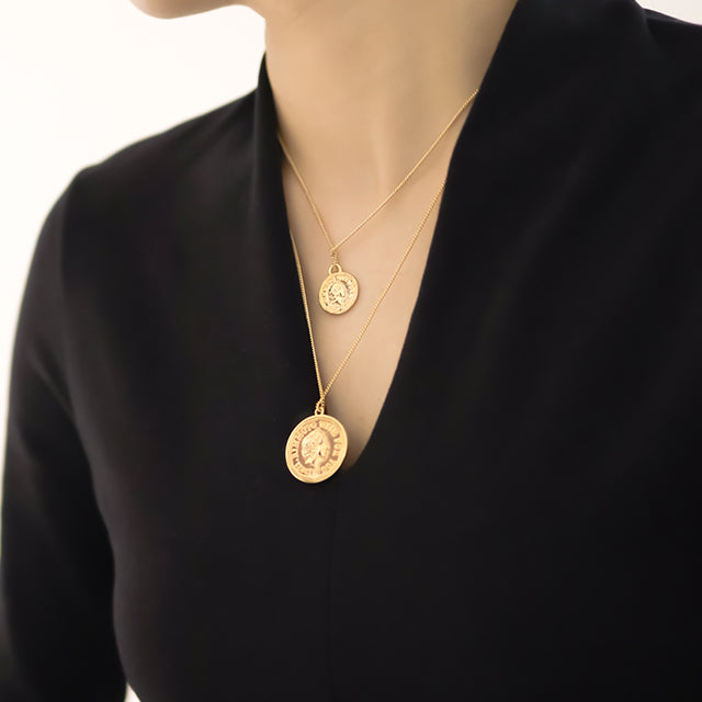 Women wear two sizes gold coin neckalces.