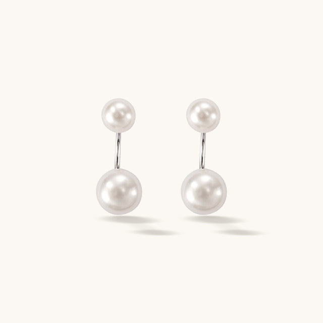 A pair of white pearl front earrings.