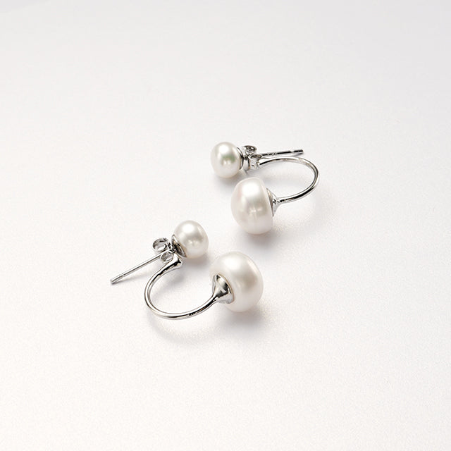 A  pair of white pearl studs.